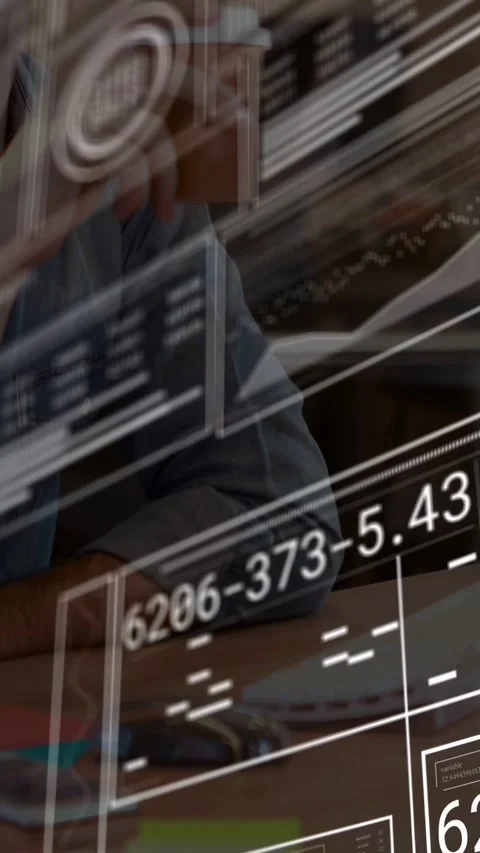 Vertical video: Man with glasses sipping coffee watching tech HUDs sliding over Stock Footage 333135419