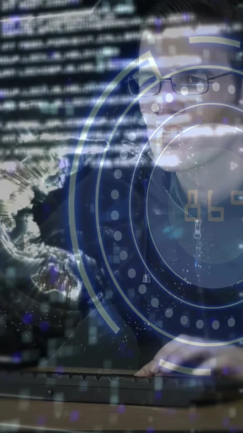 Vertical video: Man with glasses typing keyboard activating HUD globe while Stock Footage 329756312