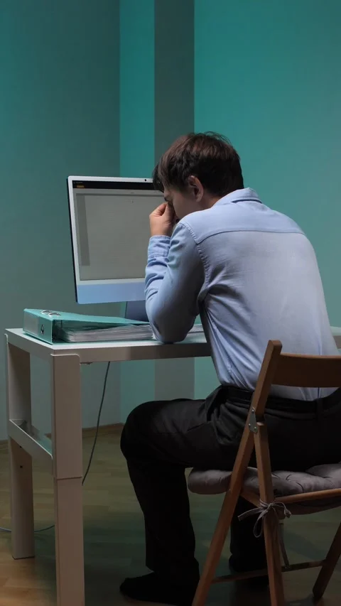 Vertical video man with glasses working on a desktop computer late at night in Stock Footage 344605802