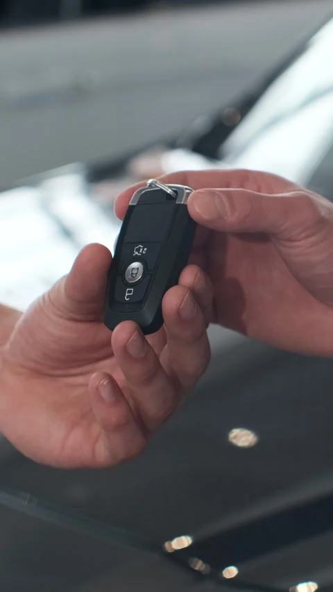 Vertical Video Man hand gives a car keys to male hand Stock Footage 337879214