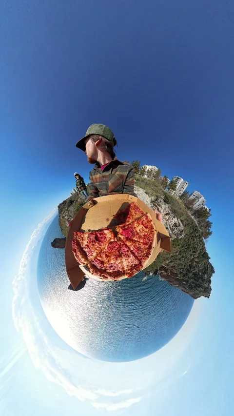 Vertical video. Man Holding a Box of Pizza with a Tiny Planet Effect, Creating a Stock Footage 304272538