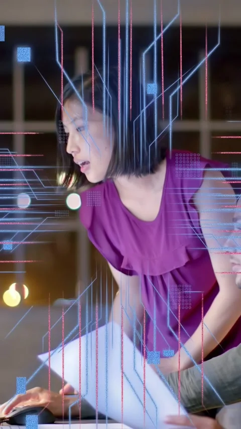 Vertical video: Man holding docs, woman clicking mouse, animating code over Stock Footage 334377683