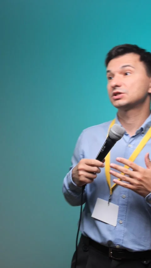 Vertical video man holding a microphone and gesturing with his hand, actively Stock Footage 342774584