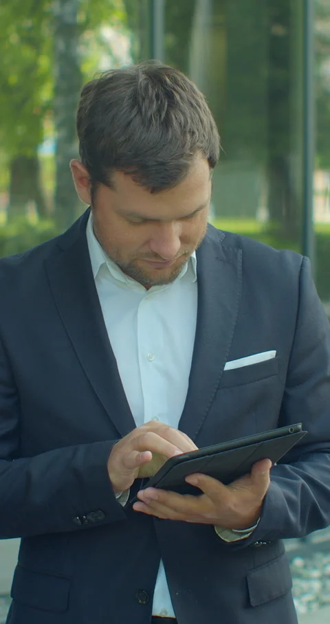 Vertical video. Man Holding Modern digital tablet. Stock Footage 345586133