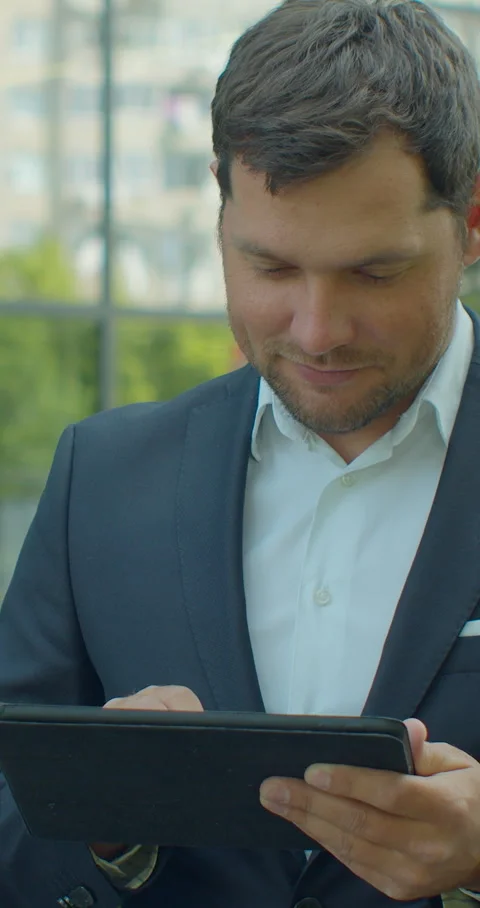 Vertical video. Man Holding Modern digital tablet. Stock Footage 345588052