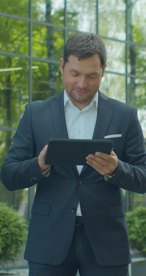 Vertical video. Man Holding Modern digital tablet. Businessman Typing Stock Footage 345588124