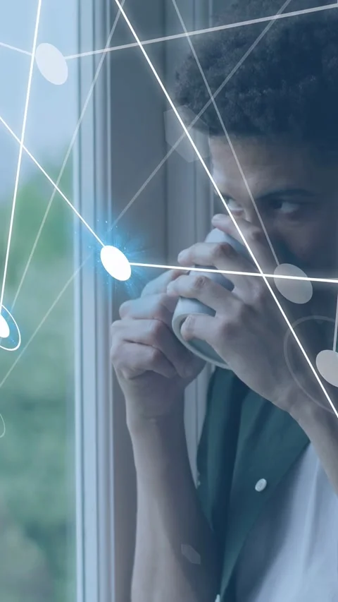 Vertical video: Man holding mug at window, network nodes rising and matching Stock Footage 333840375
