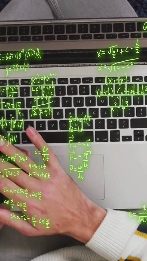 Vertical video: Man holding phone near laptop and typing, initiating math Stock Footage 334792904