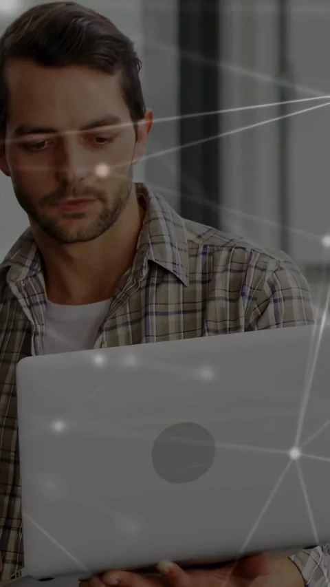 Vertical video: Man with laptop looking down, showing network nodes for tech, Stock Footage 334381854