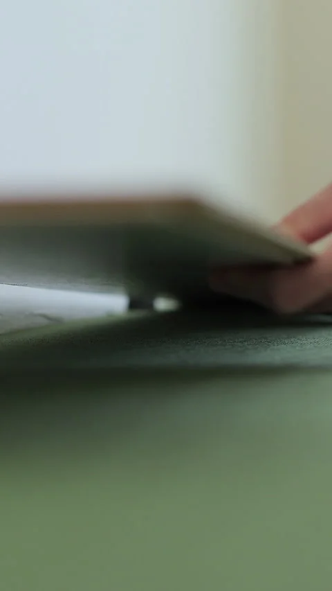 Vertical video Man lays laminate flooring on the floor in a room. Stock Footage 339060247