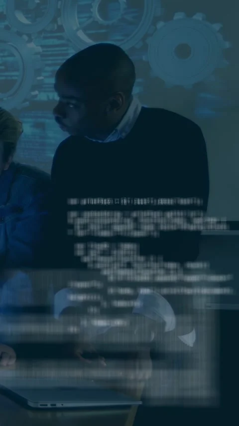 Vertical video: Man leaning and gesturing at laptop, causing code scrolling for Stock Footage 334792668