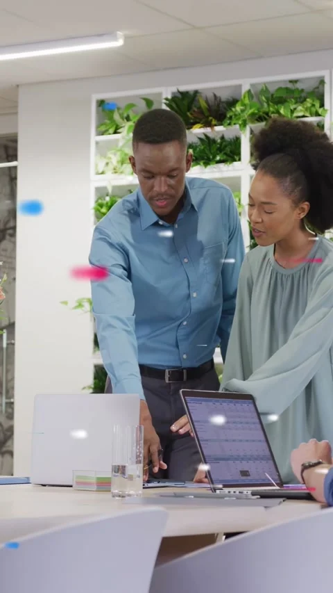 Vertical video: Man leaning and pointing at laptop, woman pressing keys, working Stock Footage 340133512