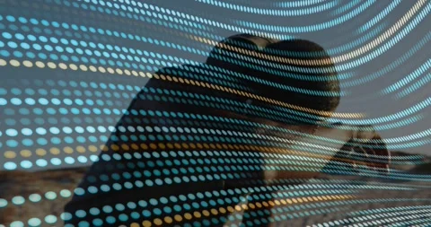 Vertical video: Man leaning checking device as blue-yellow dots overlay sweeping Stock Footage 331272972