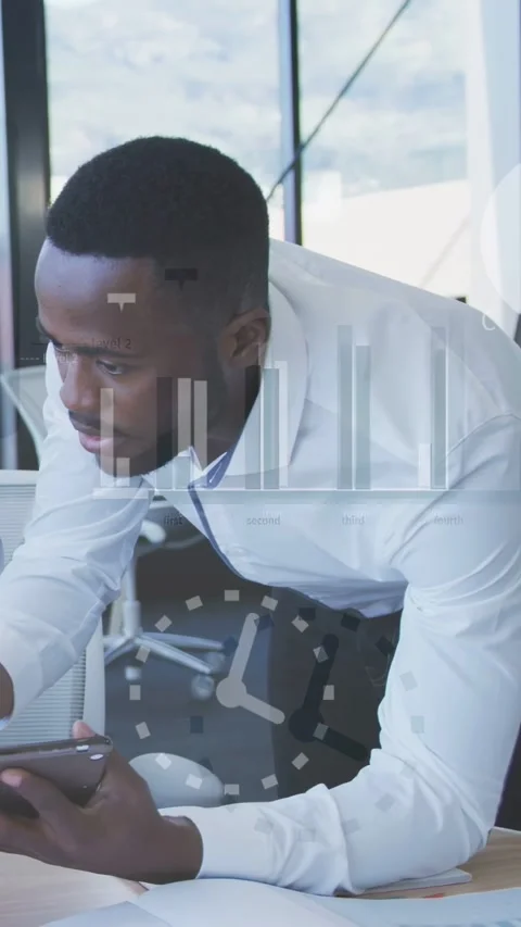 Vertical video: Man leaning on desk tapping device and creating charts while Stock Footage 337540538