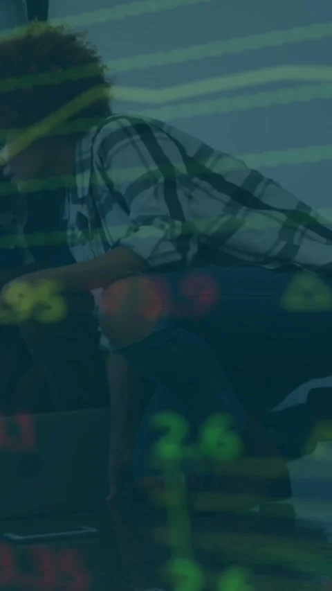 Vertical video: Man leaning on low table, tapping laptop and monitoring animated Stock Footage 334541206