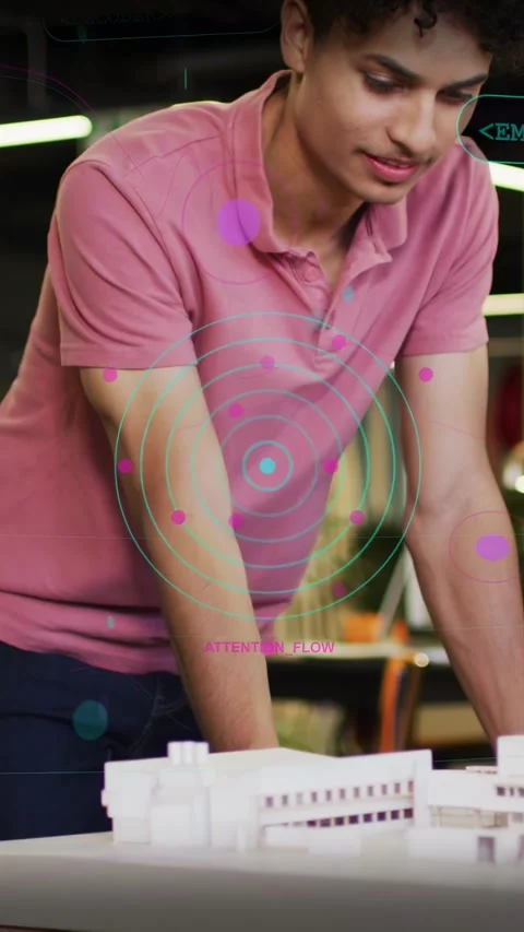 Vertical video: Man leaning over model peer pointing sparking AR tags showing Vídeo Stock 334046549