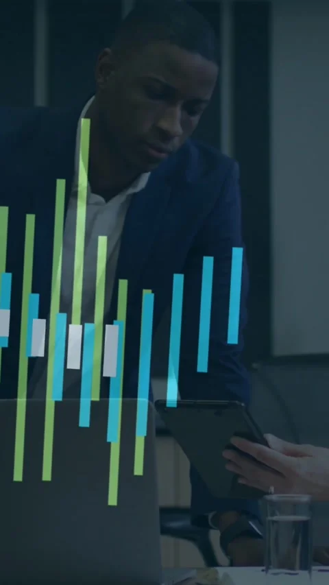 Vertical video: Man leaning over desk studying business tablet data causing Stock Footage 334541169