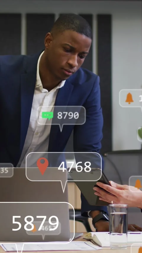 Vertical video: Man leaning on table, tapping tablet with data bubbles updating, Stock Footage 340133609