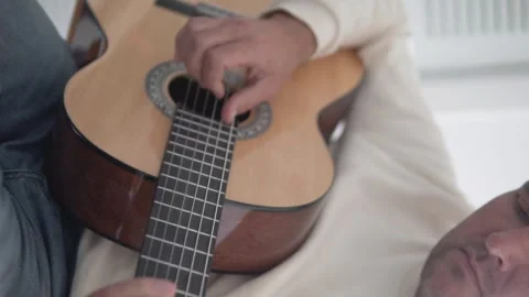 Vertical video, man learning to play the guitar, close-up Stock Footage 263228108