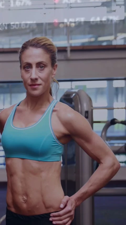 Vertical video: Man leaving, camera panning, woman posing and flexing abs to Video stock 332594980