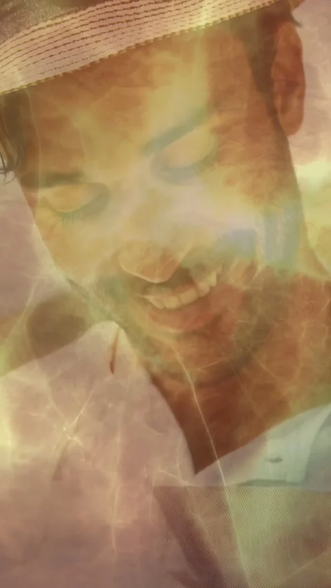 Vertical video: Man lifting head and smiling as frame shifting revealing flame Stock Footage 333595774