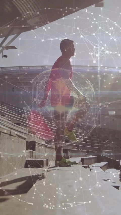 Vertical video: Man lifting knee, stepping up on stadium steps as network tracks Stock Footage 331047227