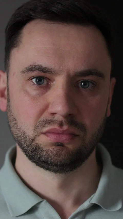 Vertical video Man looking at camera says no negative shakes head displeased Video stock 337649851