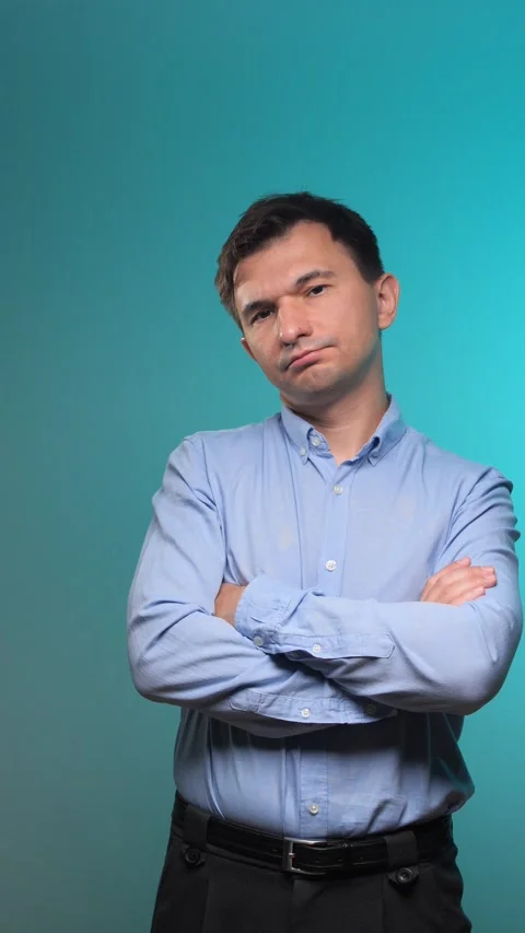 Vertical video man looking at the camera with a skeptical or thoughtful Stock Footage 342761702