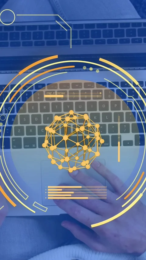 Vertical video: Man lowering phone, typing on laptop keys, yellow HUD sphere Stock Footage 334770924