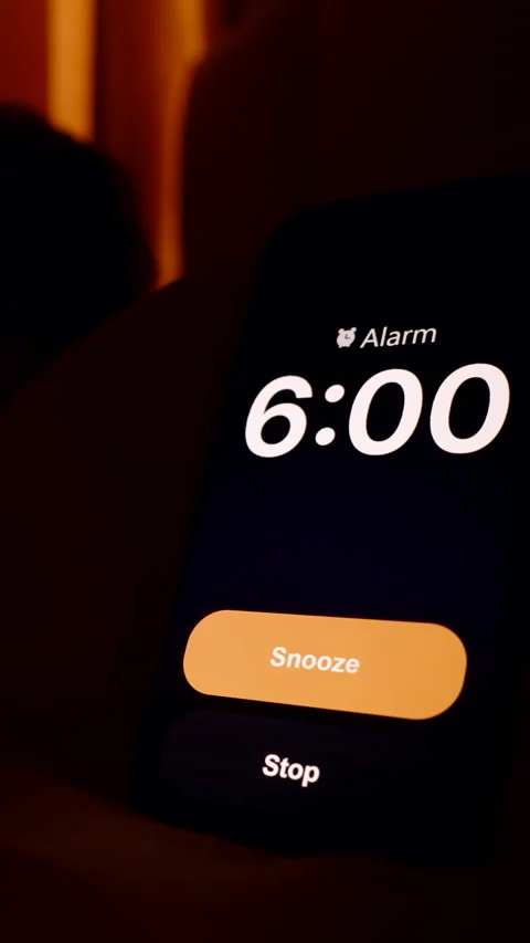 Vertical video. Man Lying in Bed Looking Toward Smartphone Alarm Ringing at 6 AM Stock Footage 319244109