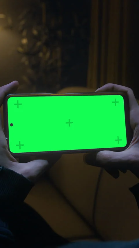 Vertical video. Man lying on couch using smartphone horizontally with chrom.. Stock Footage 297067162