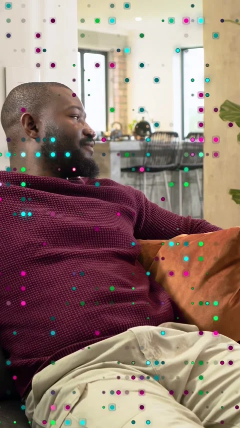 Vertical video: Man lying on sofa, camera framing face causing smiling, laughing Video stock 333527900
