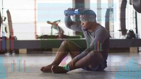 Vertical video: Man on mat resting, reaching blue bottle, cooling, hydrating, Stock Footage 332772270