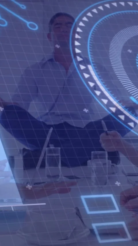 Vertical video: Man meditating at table while HUD overlaying, hands typing, Stock Footage 334540612