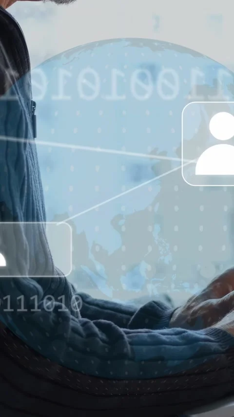 Vertical video: Man moving hands onto PC by window as overlay forming globe Stock Footage 334770729