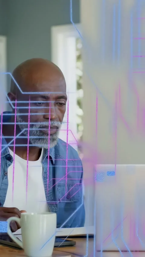 Vertical video: Man with mug reviewing code on laptop, tech neon lines rising Stock Footage 333978133