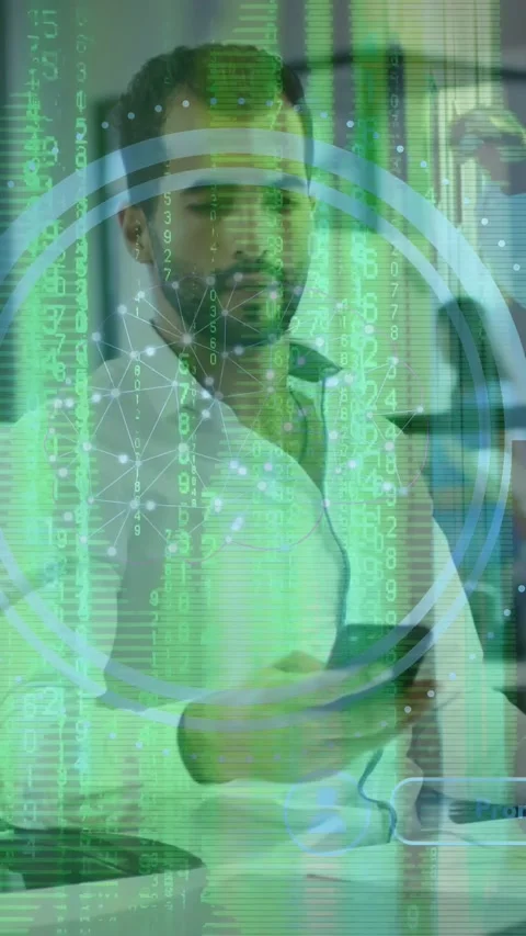 Vertical video: Man in office tapping desk, picking up phone, activating green Stock Footage 333577405