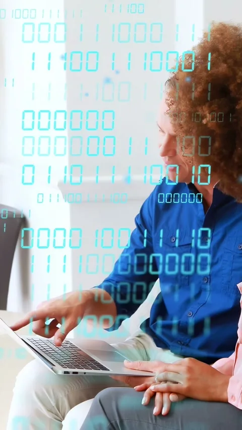 Vertical video: Man opening laptop, woman watching, binary digits flowing for Stock Footage 333978131
