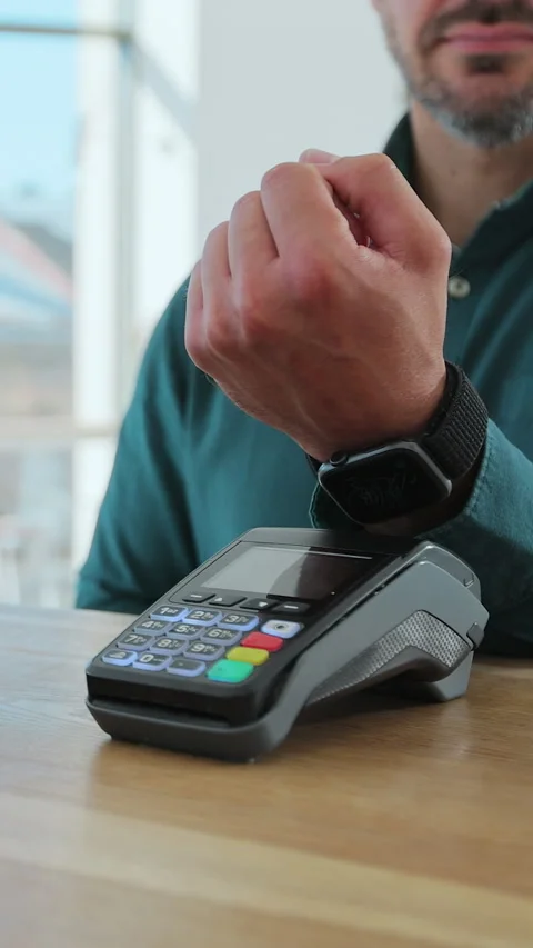 Vertical video. Man paying for coffee with nfc technology by smartwatch Stockbeeldmateriaal 343768516