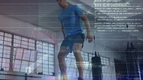 Vertical video: Man performing box jumps in gym swinging arms, landing, HUD Stock Footage 333078156
