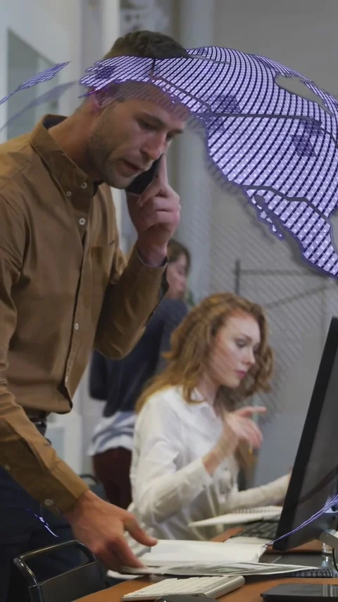 Vertical video: Man on phone clicking, causing 3D globe rotating over desk Stock Footage 334770793