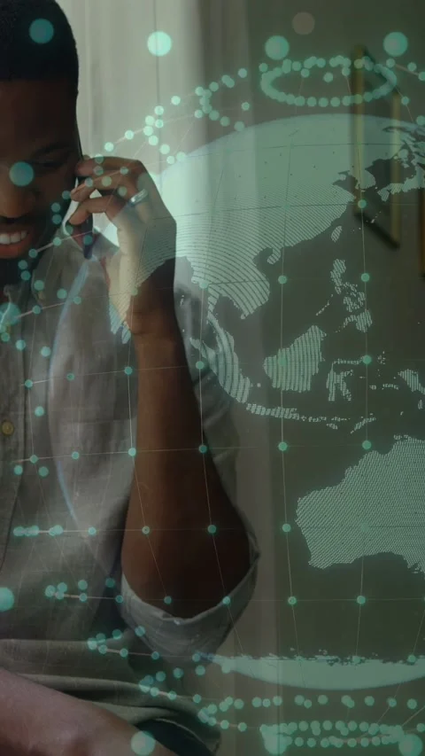 Vertical video: Man on phone talking, responding to baby's reach, tech globe Stock Footage 333603814