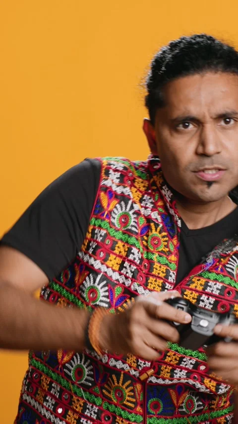Vertical video Man playing videogames with controller, studio background Stock Footage 274850217