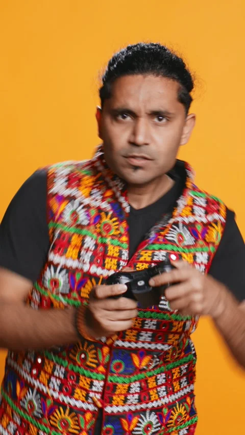 Vertical video Man playing videogames with controller, studio background Stock Footage 274913689