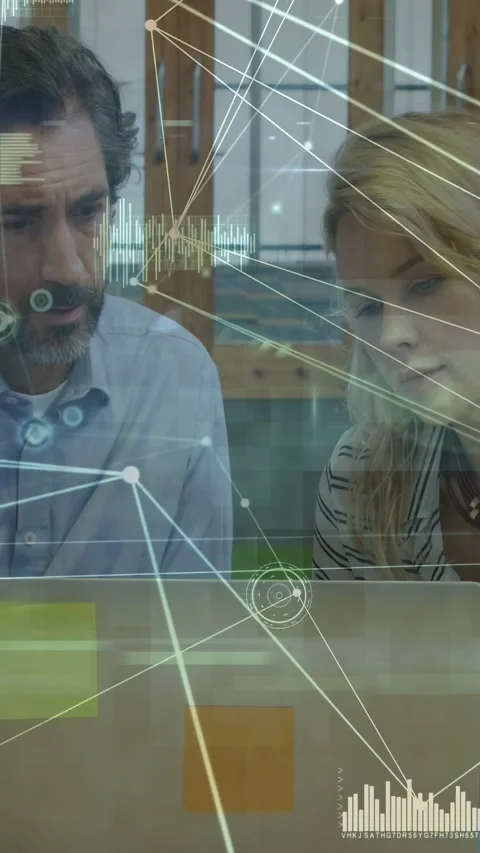 Vertical video: Man pointing and reviewing data with woman, tech laptop showing Stock Footage 333069510