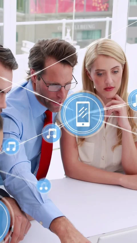 Vertical video: Man pointing, causing blue icons linking phone chat on table, Stock Footage 334391602