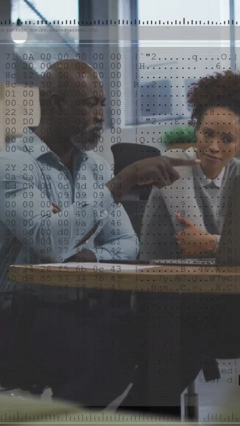 Vertical video: man pointing at laptop while woman reviewing tech code, overlay Stock Footage 332747791