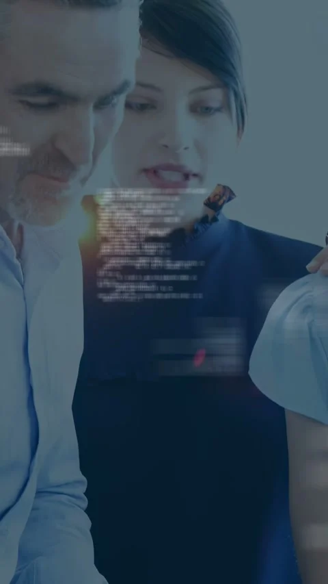 Vertical video: Man pointing marker, tech team leaning close, code on tablet and Stock Footage 334792683