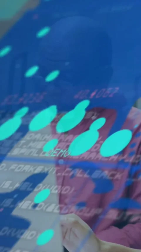 Vertical video: Man pointing at paper checking laptop sparking teal data overlay Stock Footage 332317642