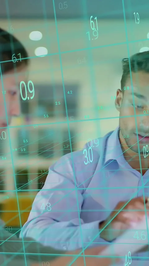 Vertical video: Man pointing pen, tapping tablet, woman leaning in, data grid Stock Footage 337540514